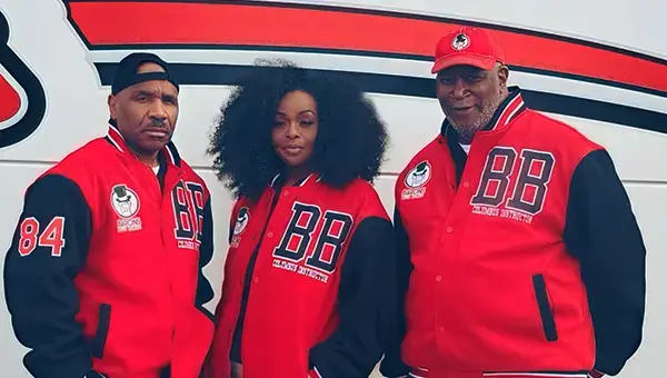 Barons Bus drivers standing outide bus wearing uniform jacket